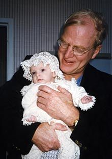 Dr. Michael Harrison holding a baby